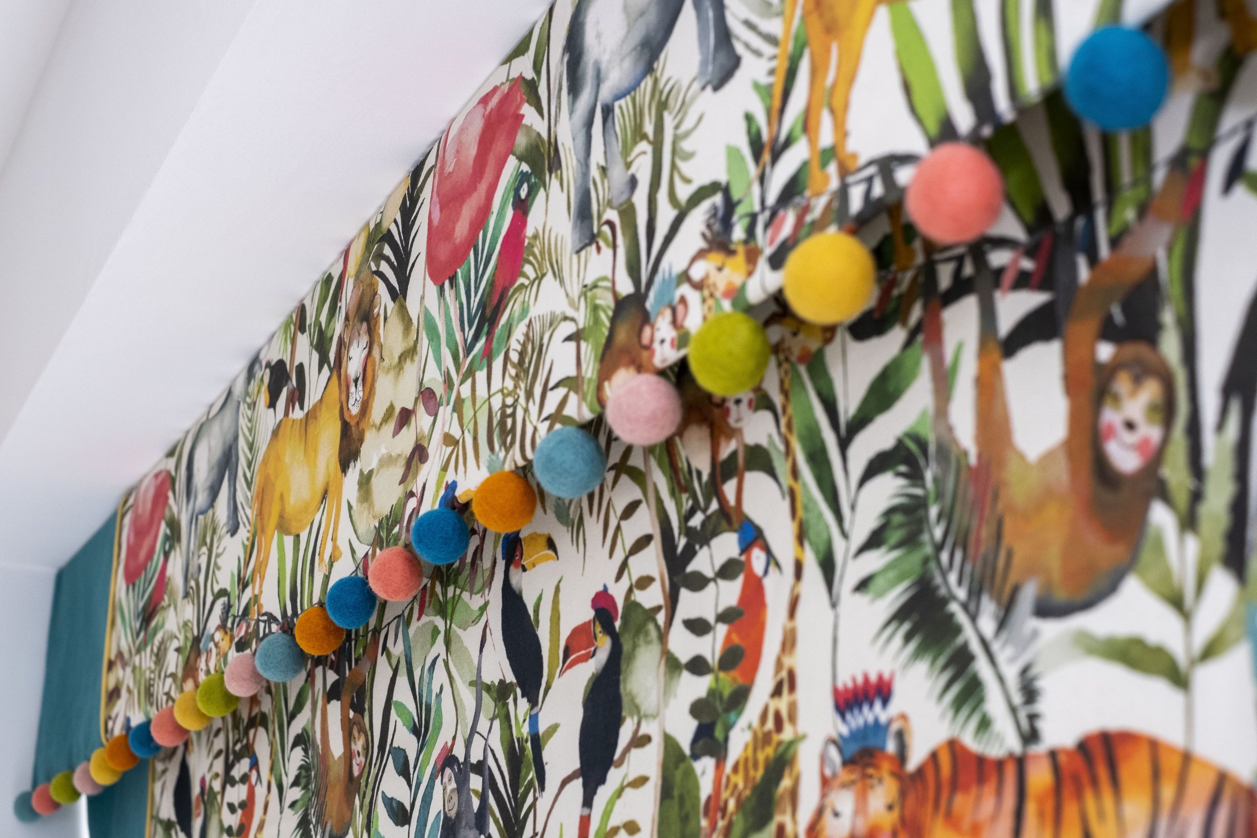 Jungle themed roman blinds with a pom-pom trim- MK Kids Interiors- London childrens interior designer