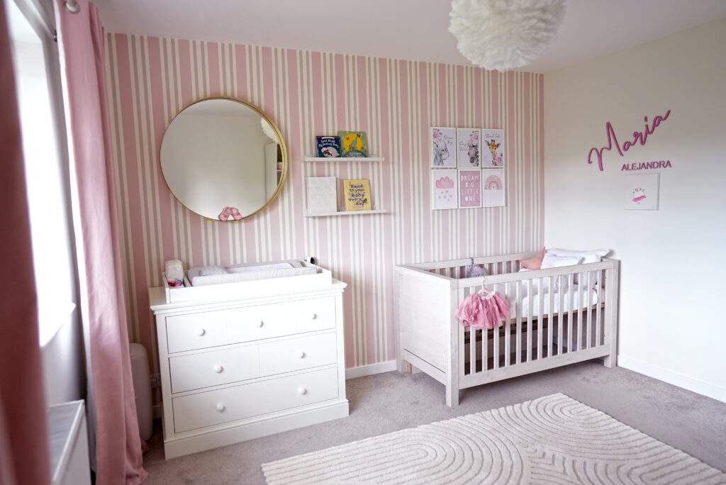Pink striped wallpaper wall in nursery- baby girls nursery