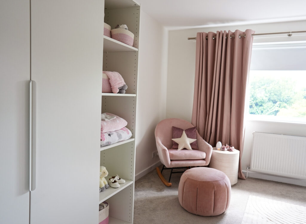 Pink rocker in baby girls nursery-white wardrobe storage-MK Kids Interiors