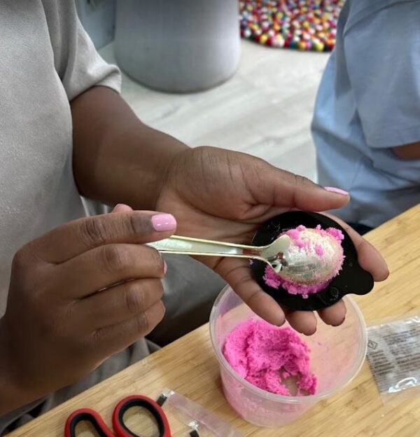 Hands holding pink Bath Bomb and mould