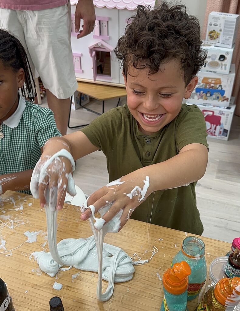 Smiling boy makes slime